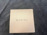 a box of gucci perfume sitting on top of a black table
