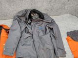 a pile of clothing and a bag on the floor