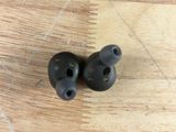 a pair of ear buds sitting on a table next to a bowl