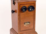 a wooden box with two black knobs on top of it