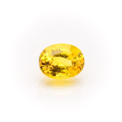 a yellow sapphire stone on a white background