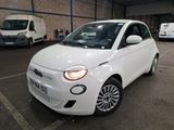 a small white car parked in a parking lot