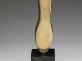 a gold sculpture of a foot on a black base