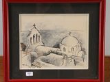 dessin d'une église dans un cadre rouge posé sur une table en bois