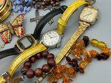many different types of watches and bracelets laid out on a table