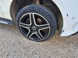 a white car that has a flat tire on it