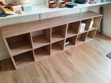 a wooden shelf with several shelves on it in a room