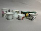 five cups sitting next to each other on a table
