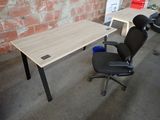 a desk with a chair and a computer on it