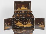 an image of a black and gold decorated box with two doors open