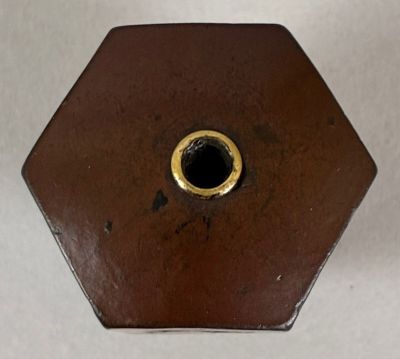a brown vase that has a hole in it