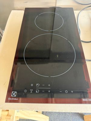 a black stove top with two burners on top of it
