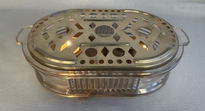 a silver box that has holes in it on a table