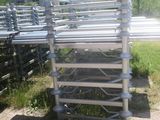 a stack of metal pipes sitting in the grass