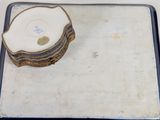 a white plate with a gold edge and a white plate with a gold edge on it
