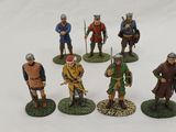 a close up of a group of figurines of men with spears and shields