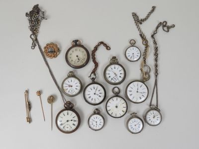 many different types of pocket watches displayed on the wall
