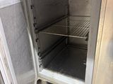 an open oven with a door that is sitting on the floor