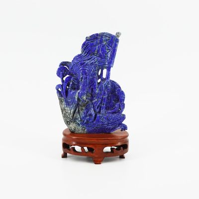 a blue vase with a dragon on it sitting on a stand