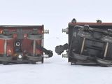 two snow plows sitting in the snow next to each other