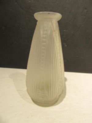 a glass vase sitting on a table with a black background