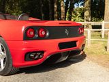 a red sports car that is parked on the side of the road