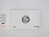a picture of a coin on a card on a table