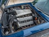 a small engine in the hood of a blue car