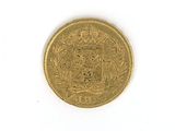 a close up of a gold coin on a white surface
