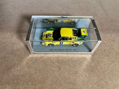 the yellow car is in a clear box on the floor