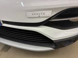 the front of a white car with a sticker on it ' s bumper