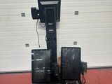 two speakers sitting on a pallet in front of a garage door