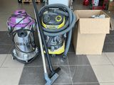 two vacuums that are on the floor in the room
