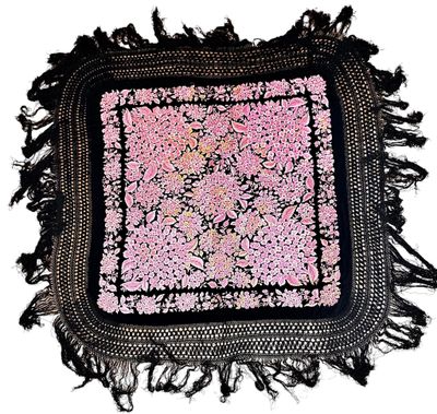 black and pink square rug with fringes on a white background