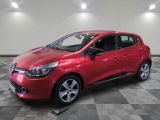 a red car is parked in a room with a checkered floor