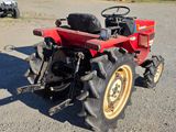 a red tractor that is parked in the dirt