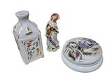 a small vase and a small vase with a figurine on it