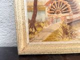 a picture of a painting of a water wheel on a table