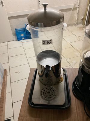 a blender sitting on top of a wooden table next to a coffee maker