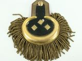 a picture of a gold and black mop head on a white surface