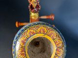 a decorative object that looks like a drum on a stand