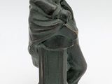 a statue of a man sitting on top of a pedestal