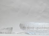 a glass bowl and a glass bowl sitting on a table