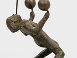 bronze sculpture of a man with three balls on his head