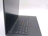 a black laptop with a red button on the keyboard