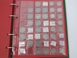 a red binder with a lot of silver coins in it