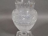 a clear glass vase sitting on top of a glass stand
