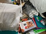 a cardboard box full of books and other items in it