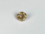 a close up of a yellow diamond on a white surface