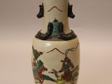 a white vase with a picture of a man on horseback on it